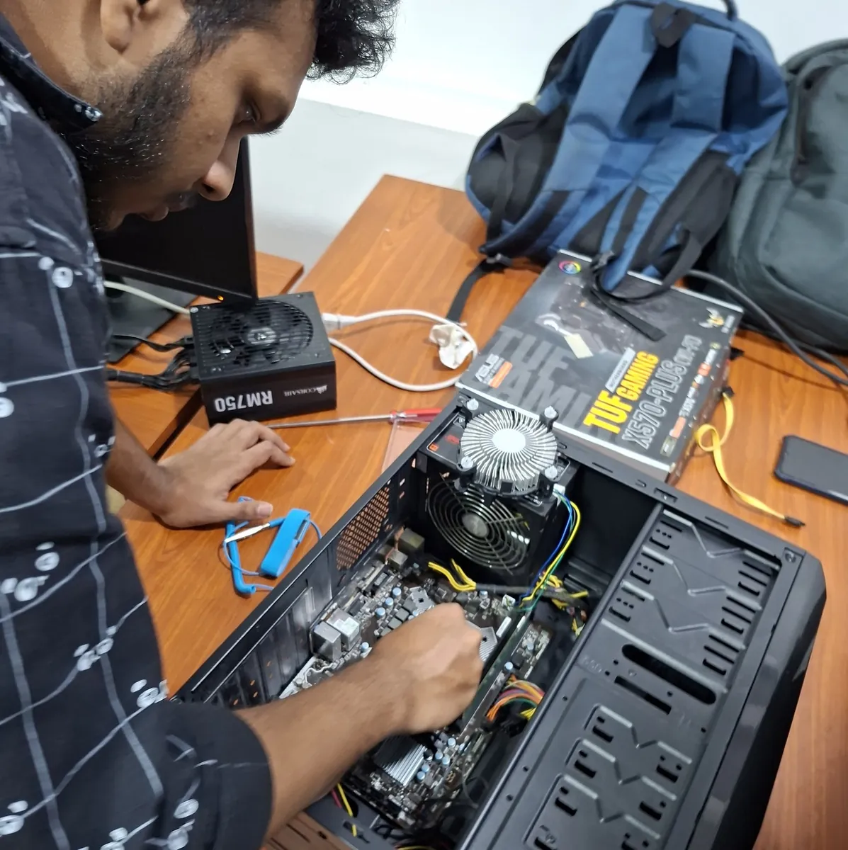 Student assembling a desktop computer during the PCG Hardware Bootcamp